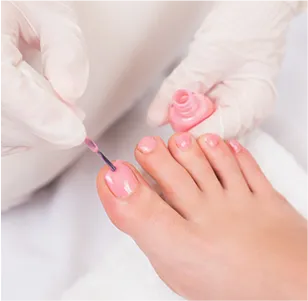 Women pedicure with pink nail polish